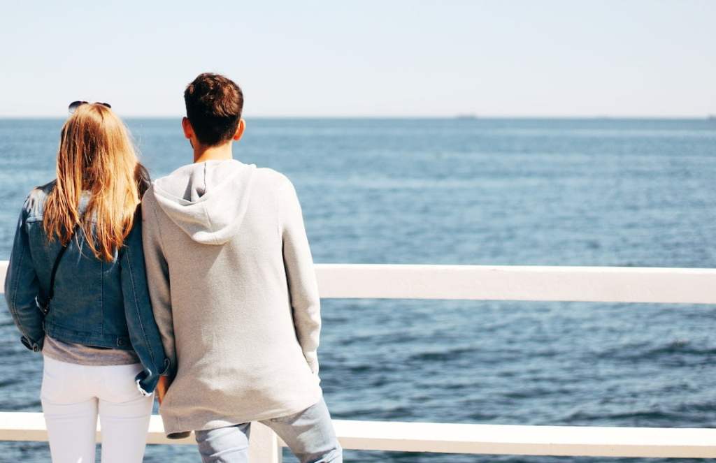 Couple holding hands by the ocean
